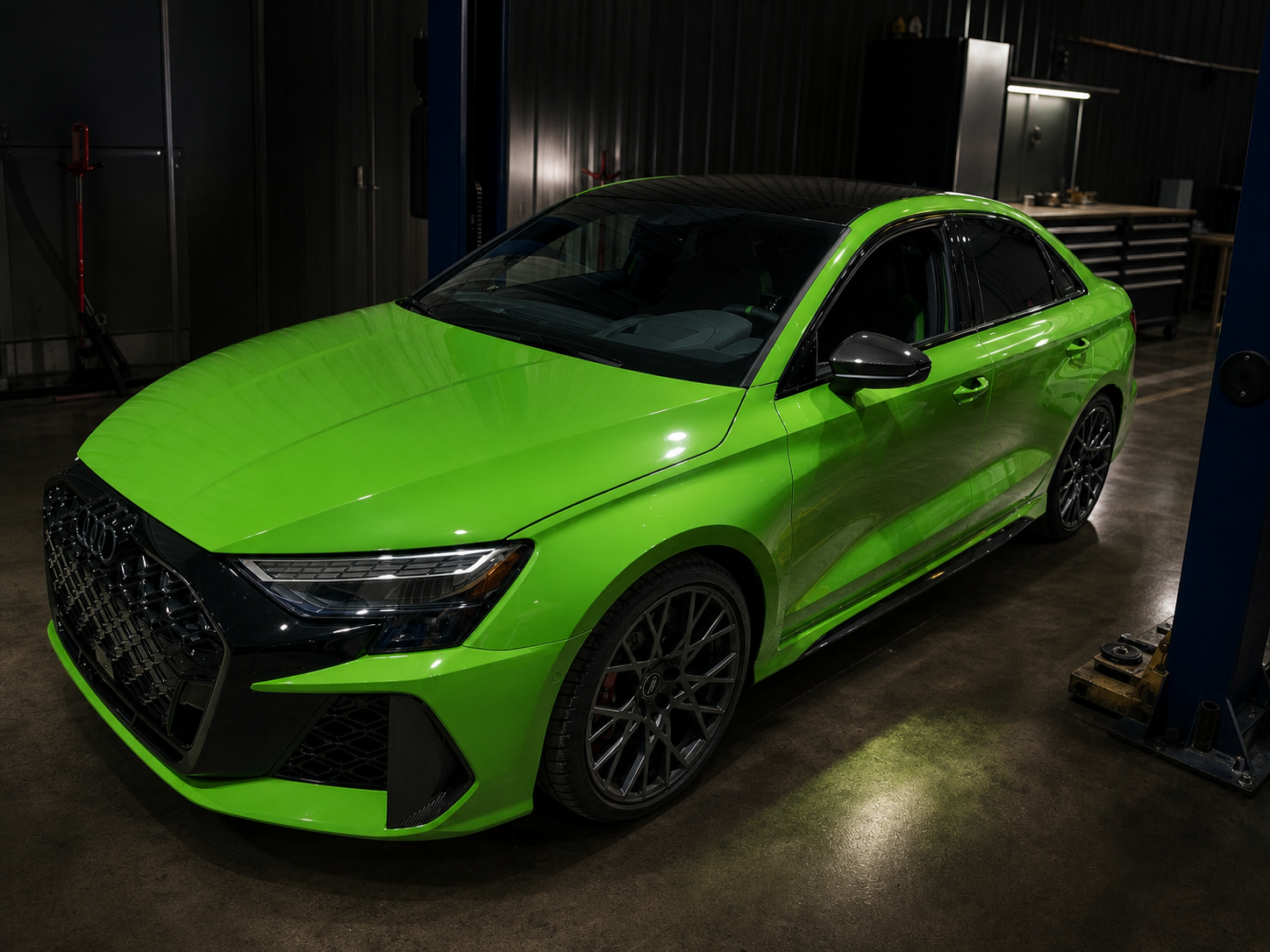 Bright green Audi sedan in the JA Tuning shop