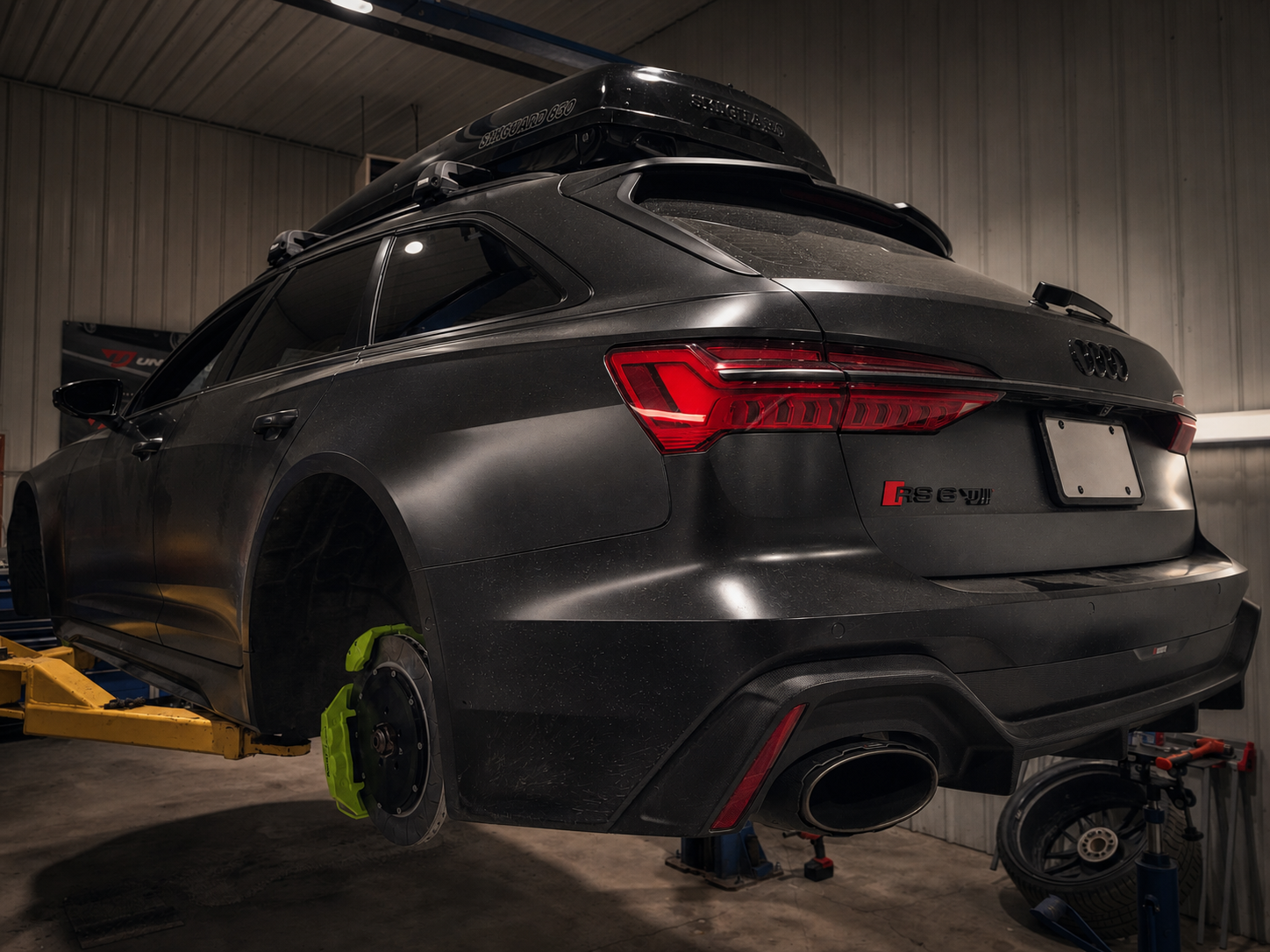 Audi RS6 on a lift with license plate blanked