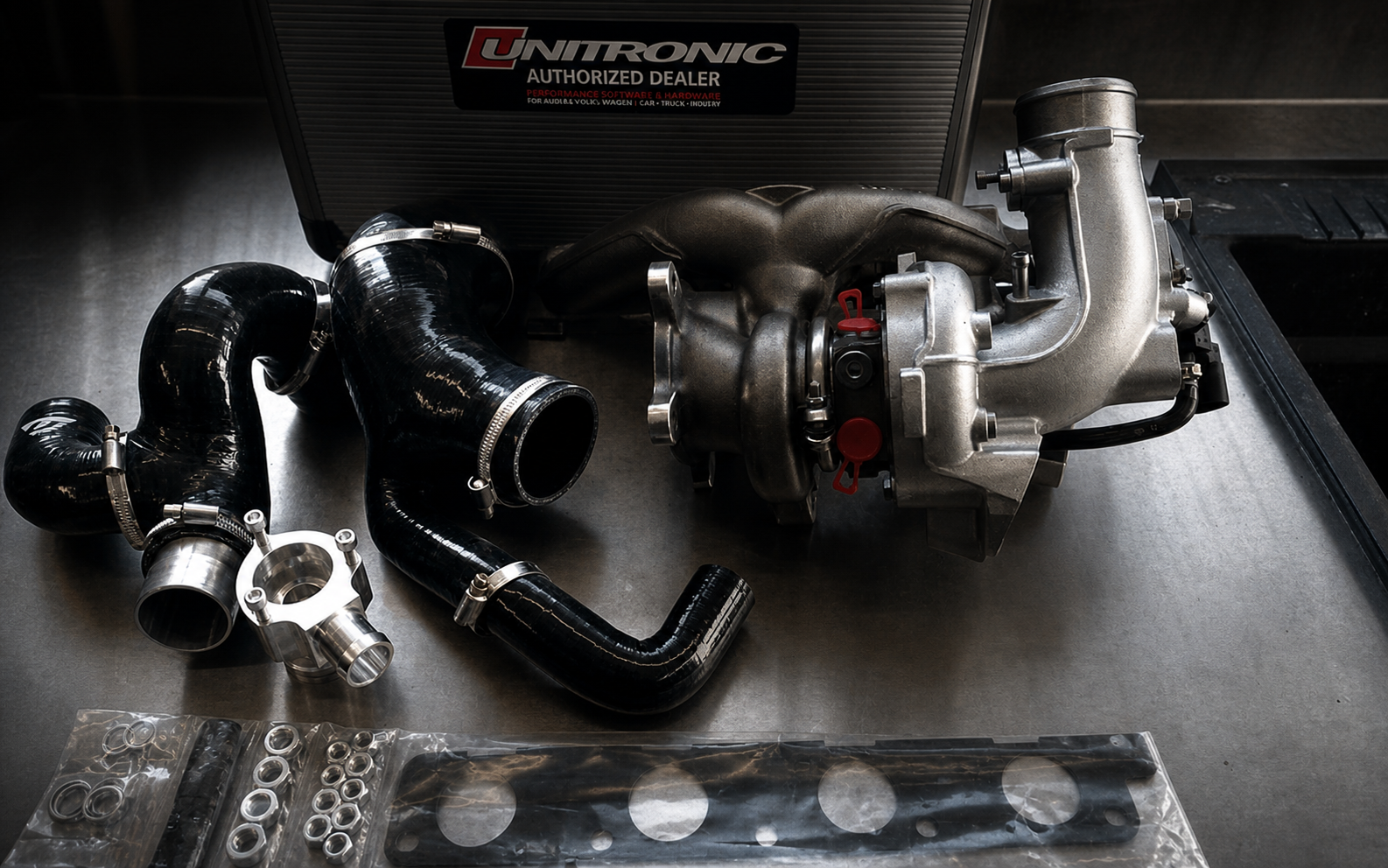 Unitronic turbo hardware laid out on a workbench